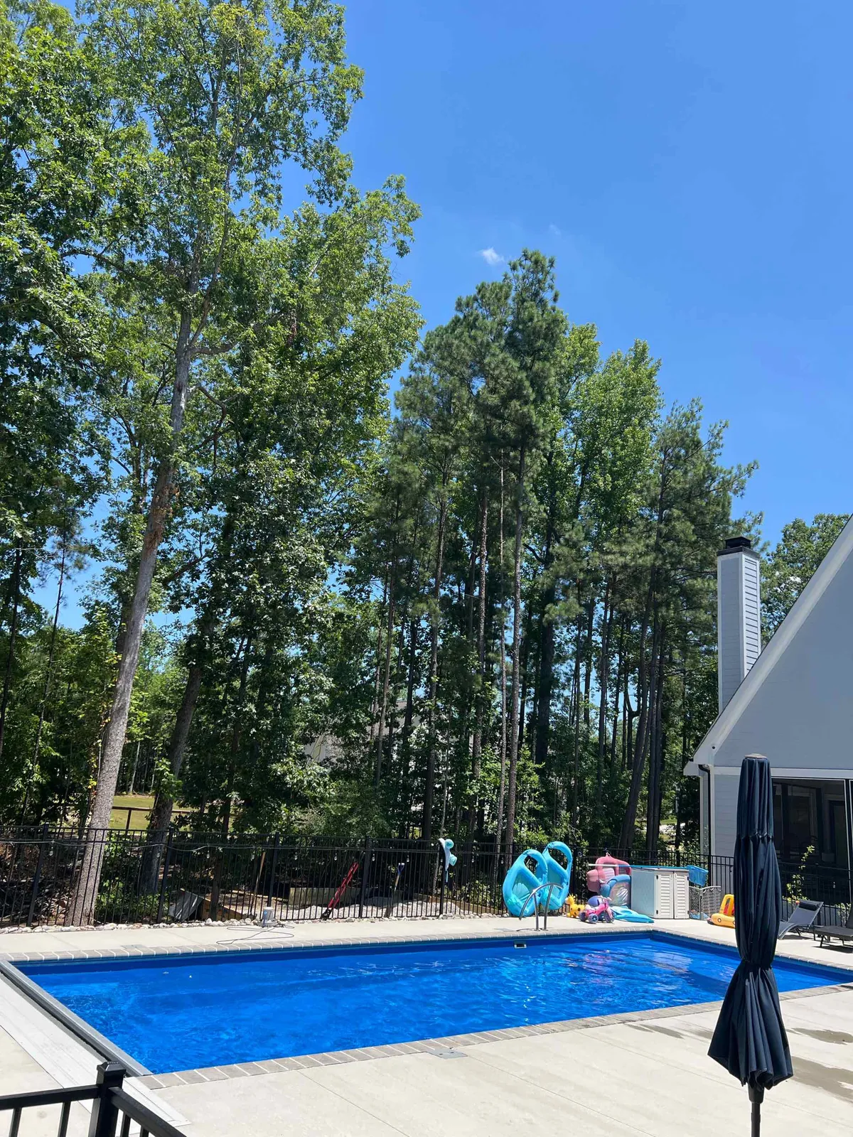 A family pool with floats in the water, ready for the weekend